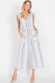 Stripes are huge this season! Pastel colored stripes on the linen blend is a woven fabric, tie details on top of the shoulders! Separate Waist Ties, Sleeveless romper with a fitted look. Made in the USA