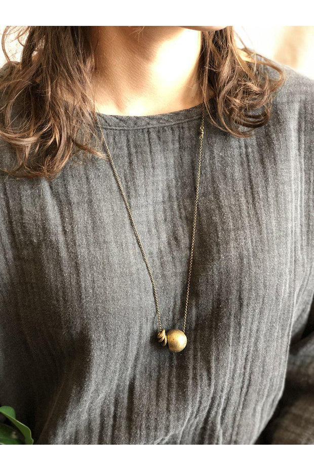 This necklace is unique in that it is a bit shorter in length than a traditional necklace which makes it perfect for layering!  Handmade in Minnesota Recycled brass beads from Ghana